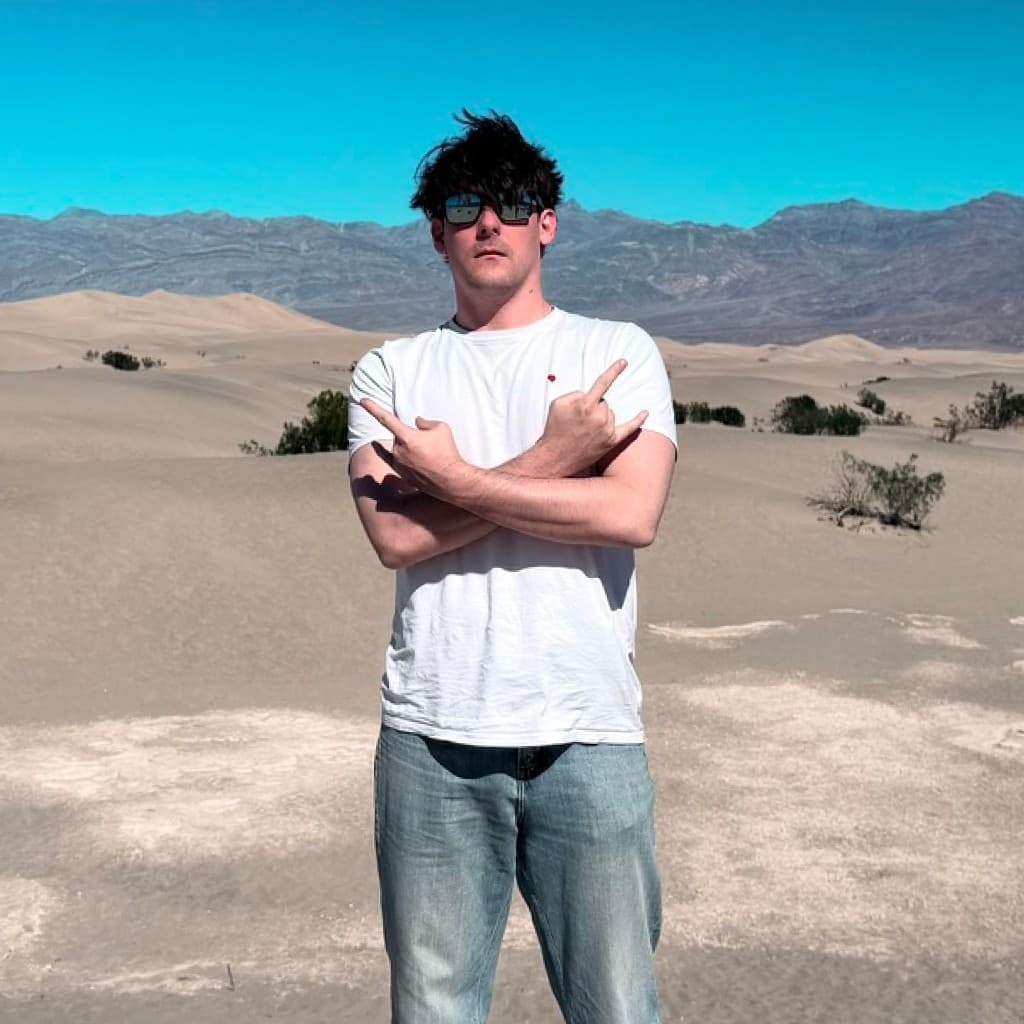 Shaun in the desert with mountains in the background